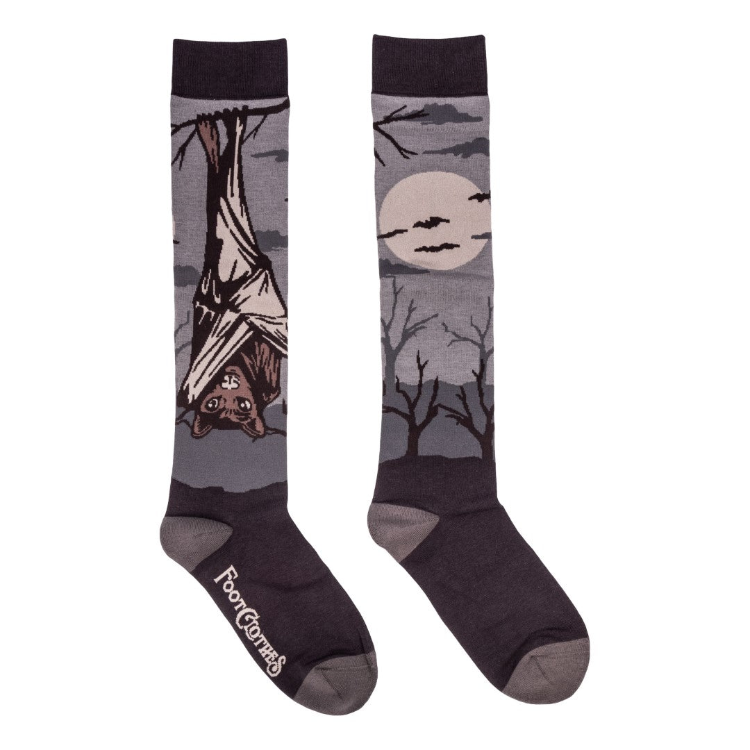 Pair of socks with bat and moon design on a white background