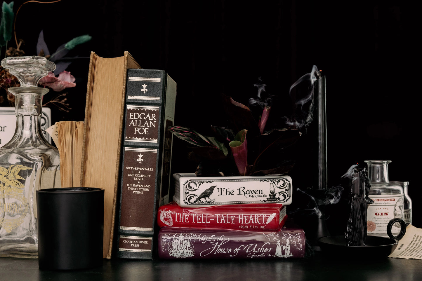 Stack of books with Poe's works on a dark background