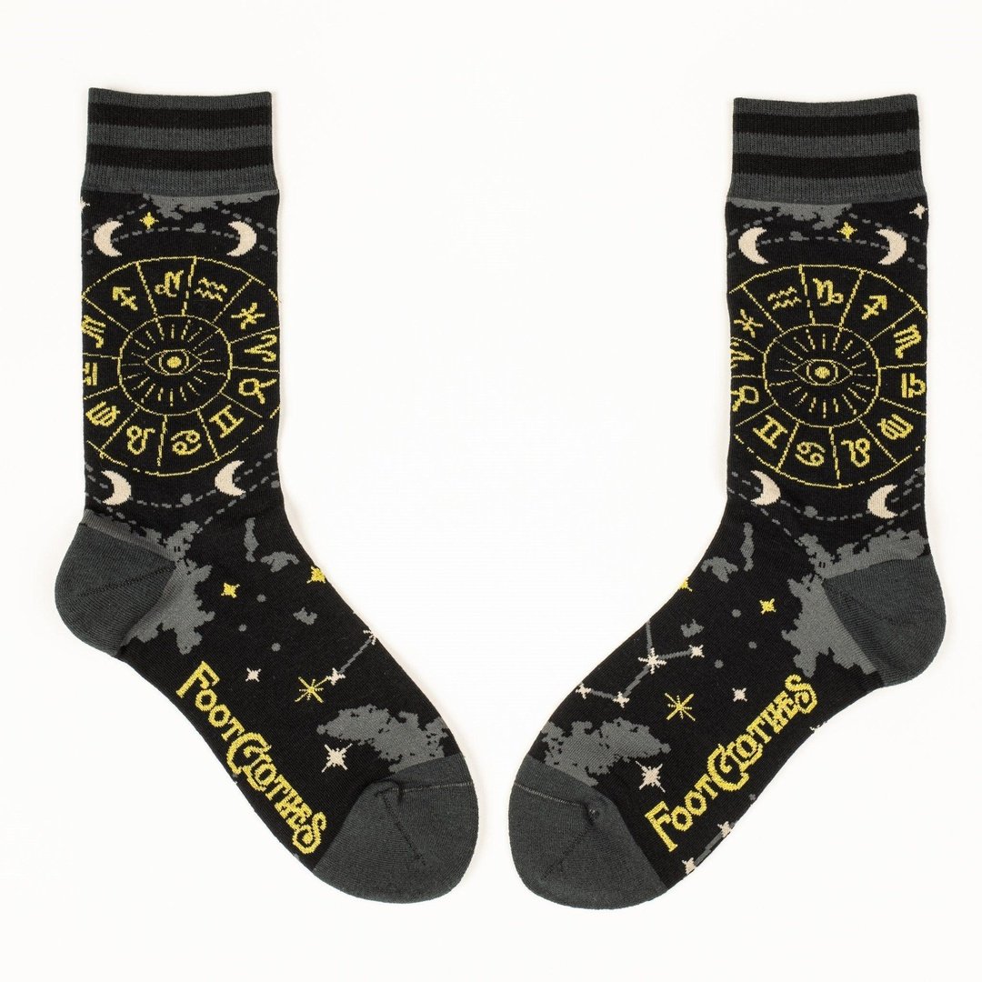 Black socks with yellow astrological design and 'Foot Clothes' branding on a white background