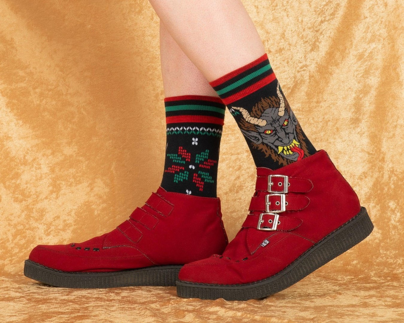 Red boots with patterned socks on a beige background