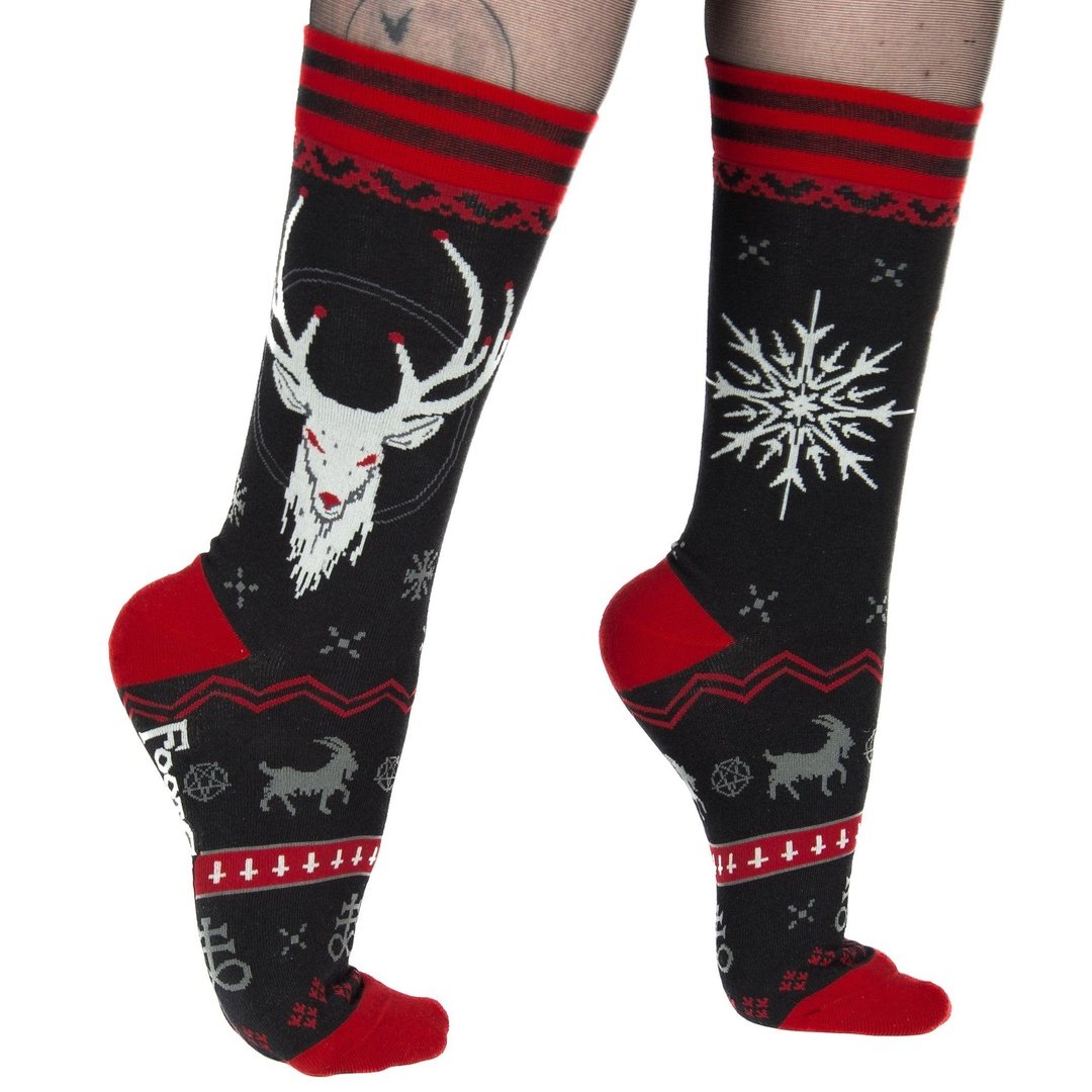 Black knee-high socks with red and white patterns featuring a deer head and snowflake design.