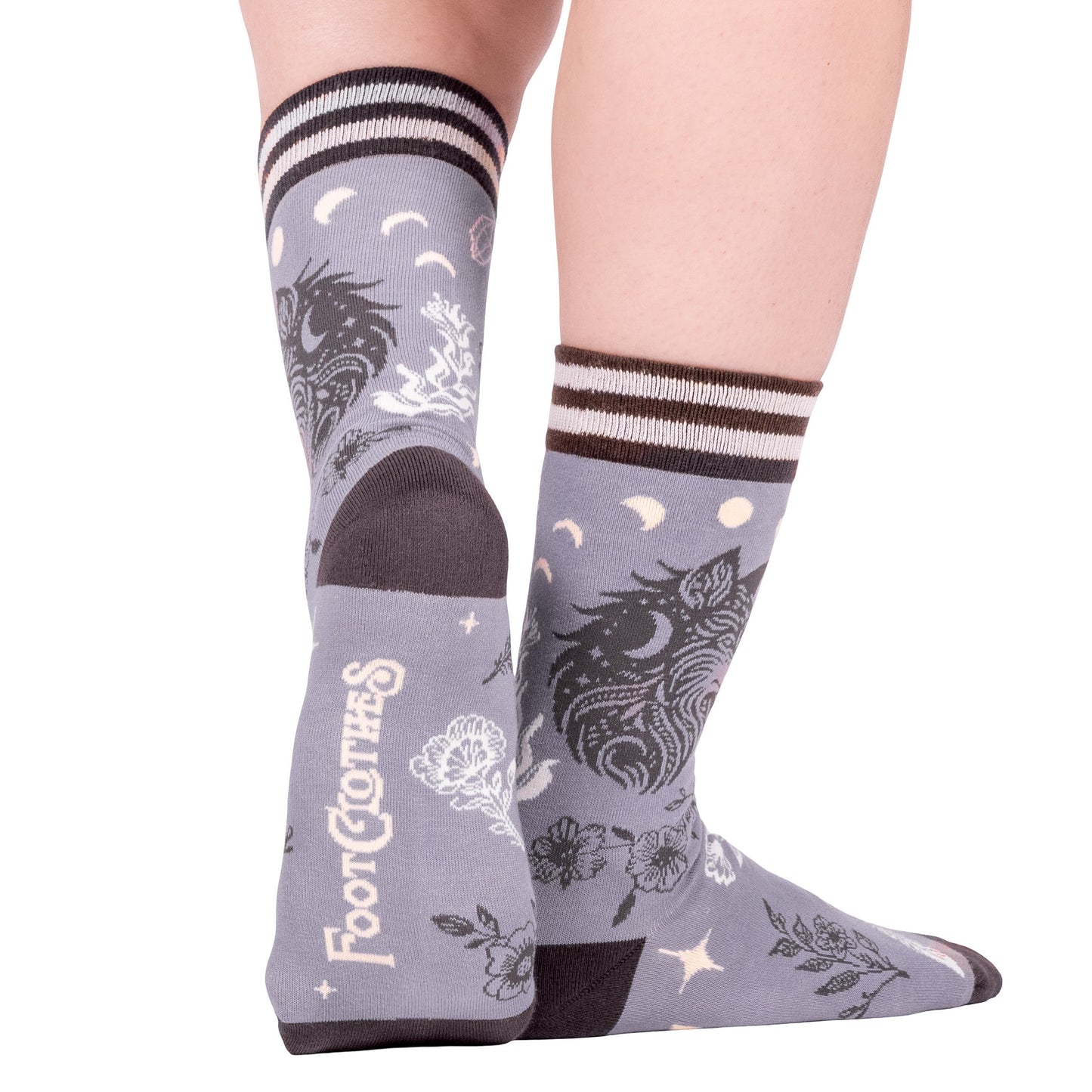 Gray socks with unicorn design worn by a person on a white background