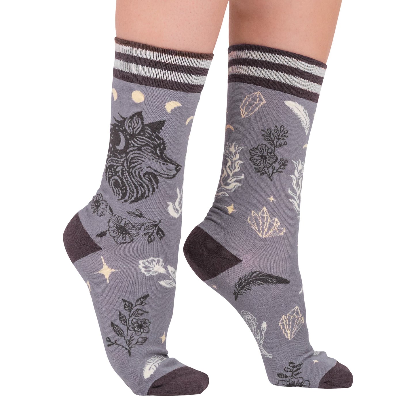 Gray socks with nature-themed designs worn by a person on a white background