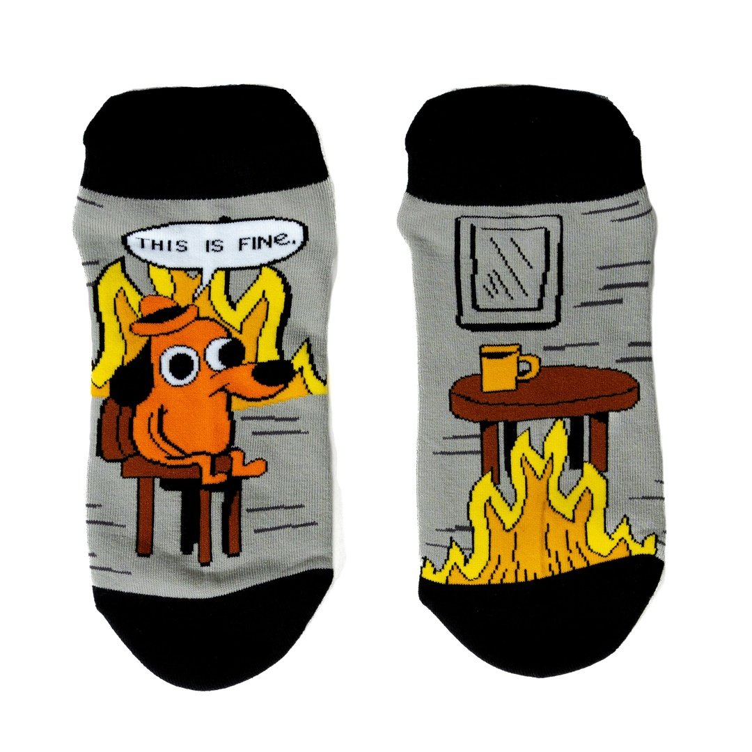 Two socks with cartoon designs of a dog and a fireplace on a white background