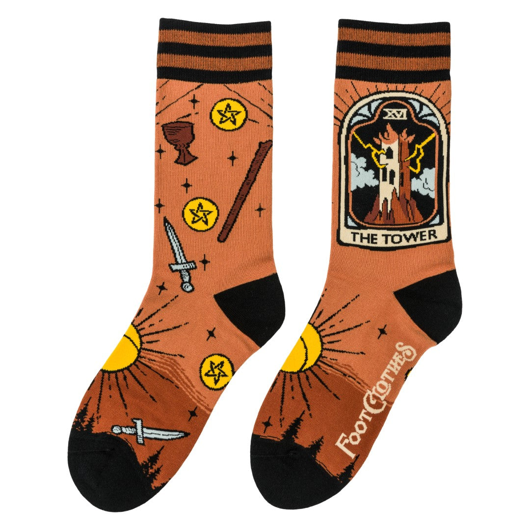 Pair of socks with tarot card design and 'The Tower' illustration on a white background