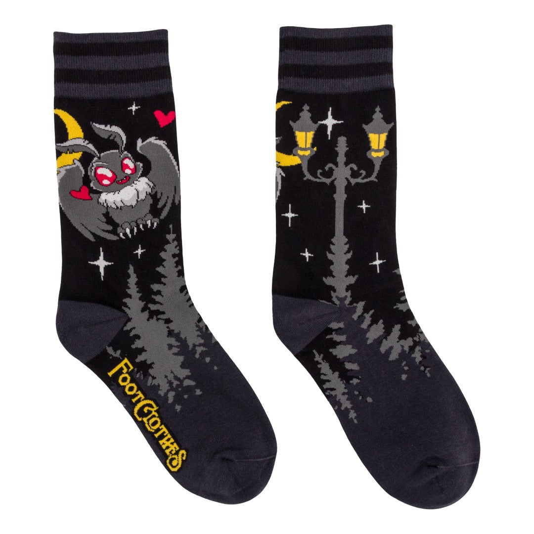 Pair of socks with cartoon bat and lamp design on a white background