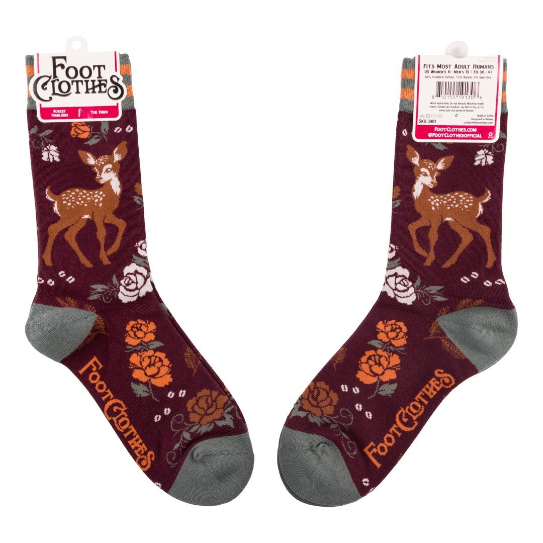 Pair of maroon socks with deer and floral patterns on a white background