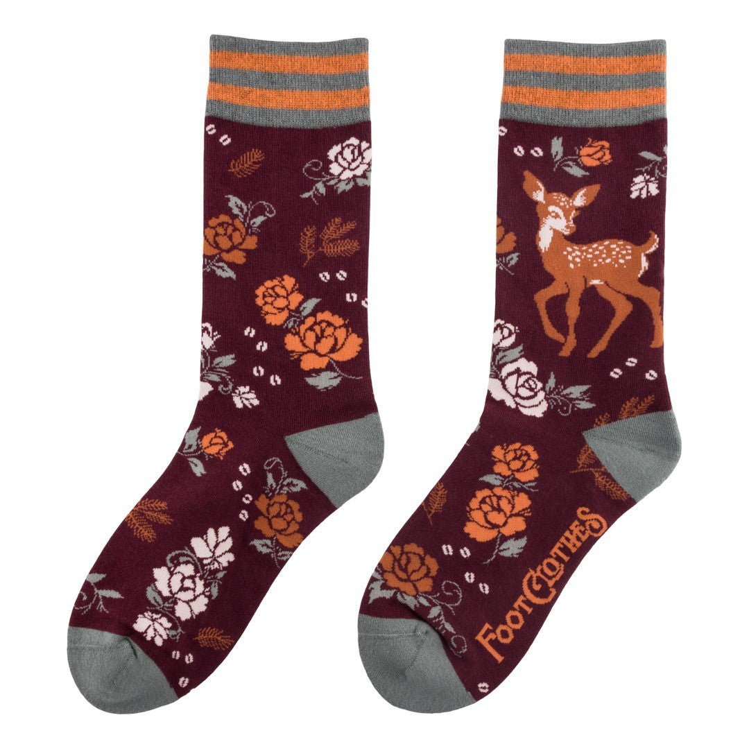 Maroon socks with floral and deer pattern on a white background