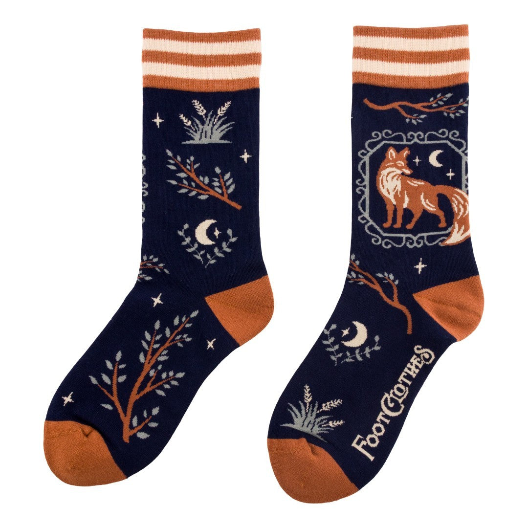 Pair of socks with fox and nature design on a white background