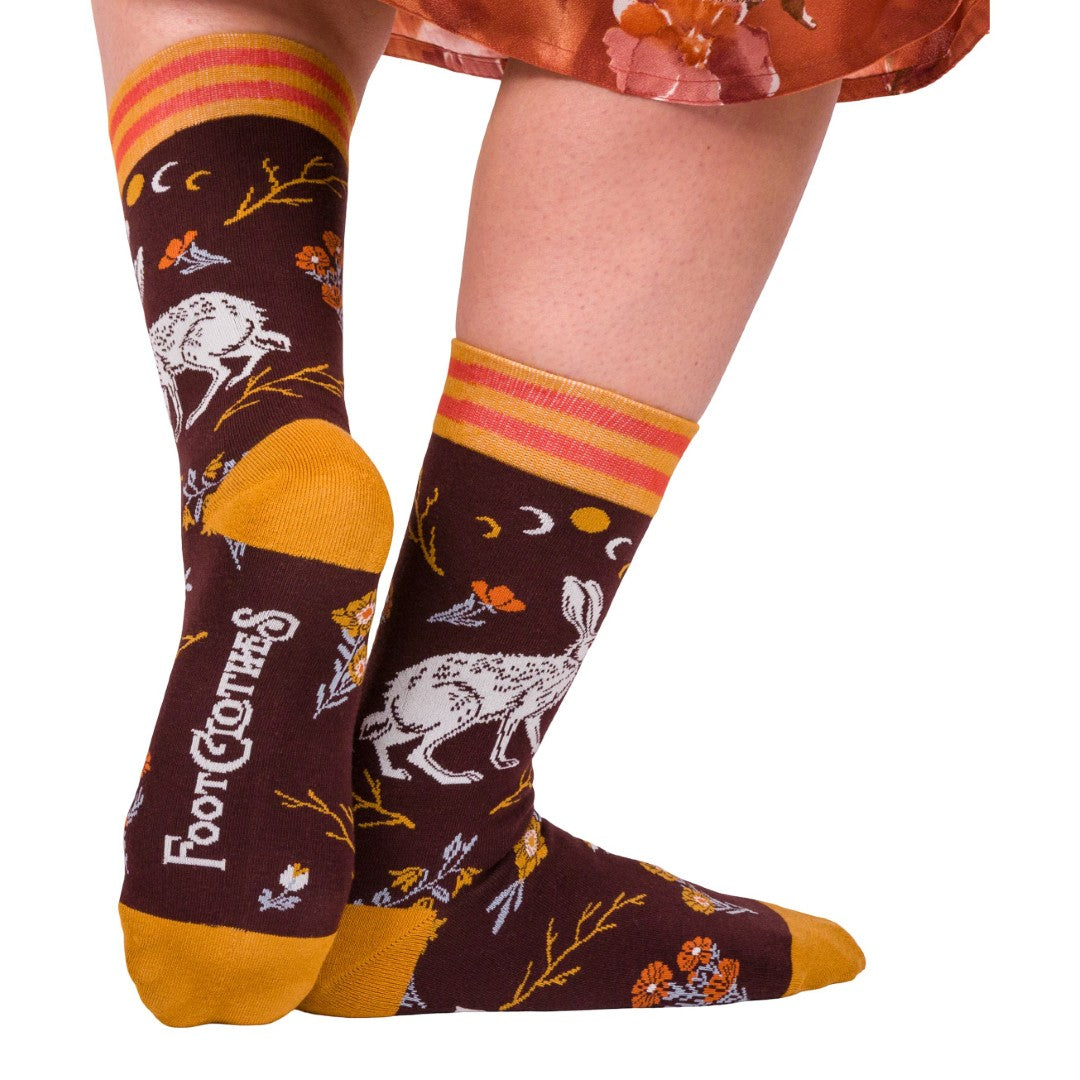 Pair of socks with a hare design and colorful patterns on a white background