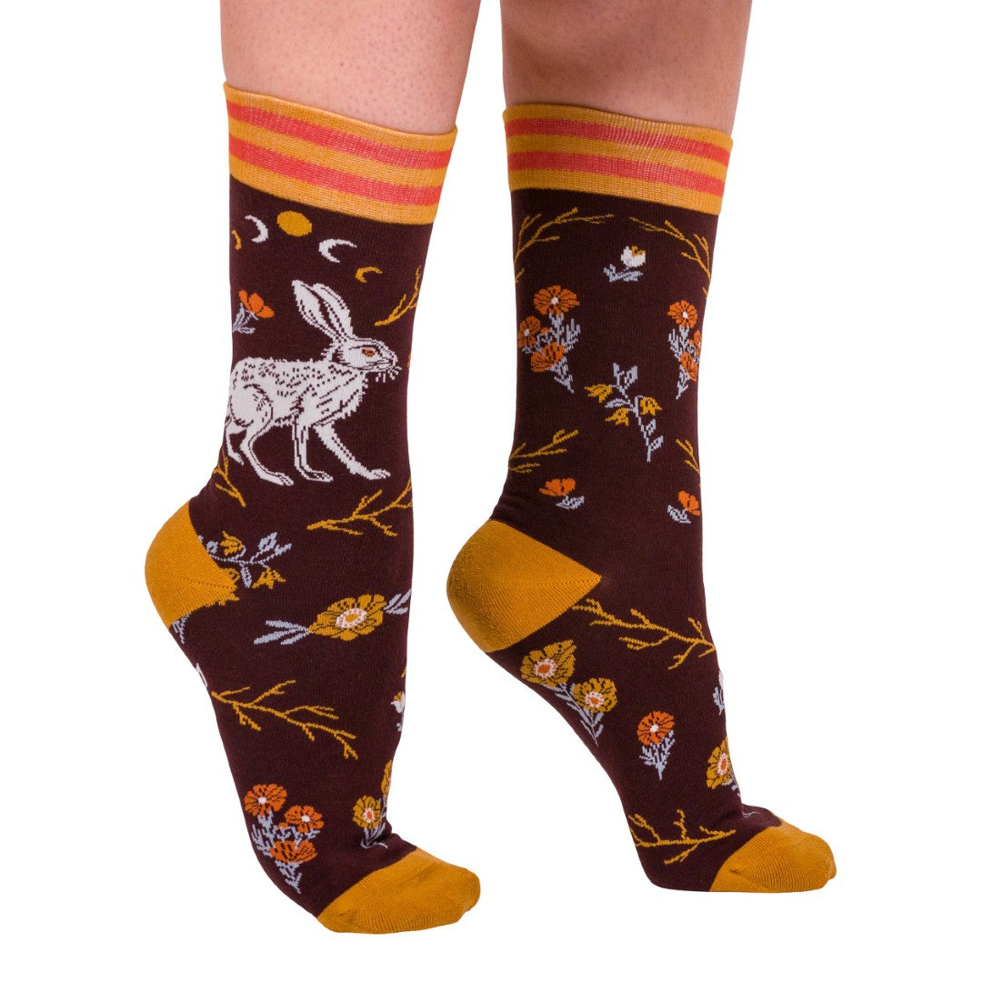 Colorful socks with floral and animal designs on a white background