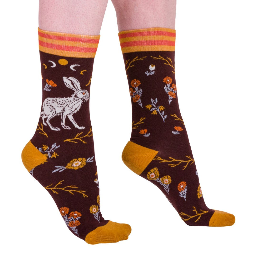 Pair of socks with rabbit and floral design on a white background