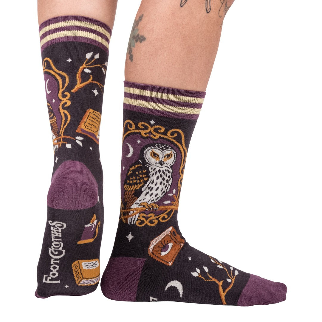 Pair of socks with owl design and purple accents on a white background