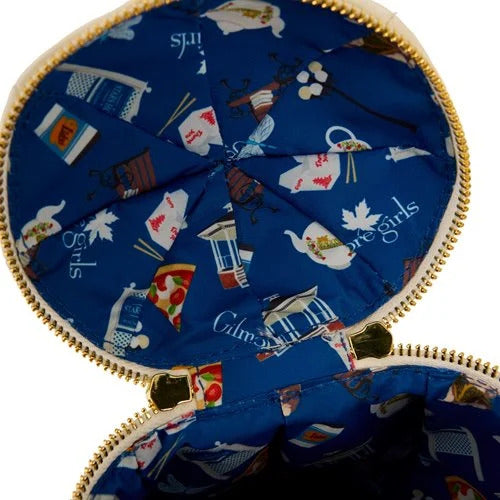 A blue fabric purse lining, opened to show details. Across the lining are drawings of images from the TV series Gilmore Girls, including a gazebo, pizza, and a teapot.
