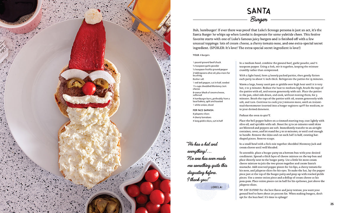 Santa-shaped cracker with cheese and olives on a plate, next to a recipe card.