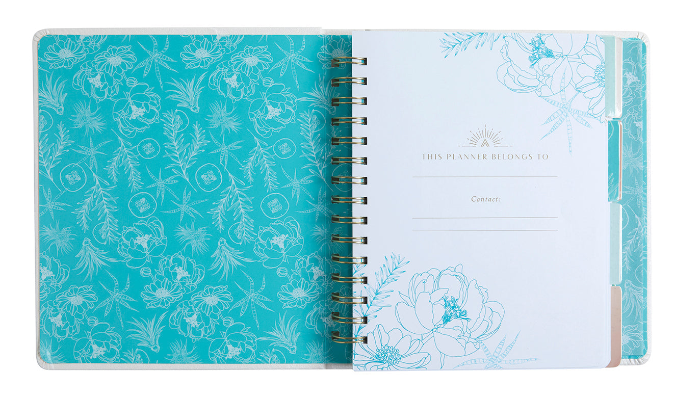 Open planner with floral design on a white background