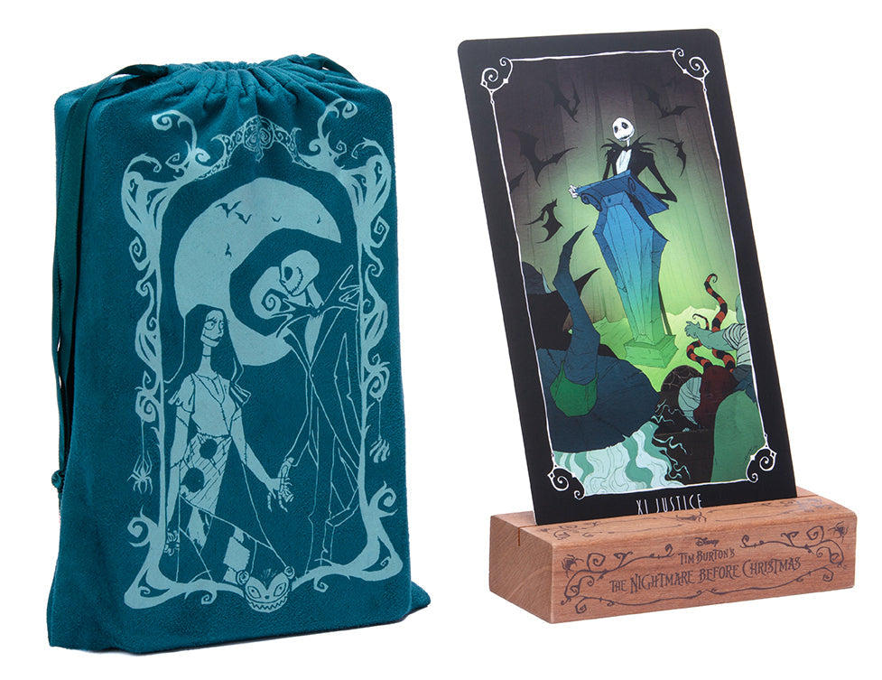 Teal drawstring bag with 'The Nightmare Before Christmas' design and a framed card featuring Jack Skellington and Sally on a stand.