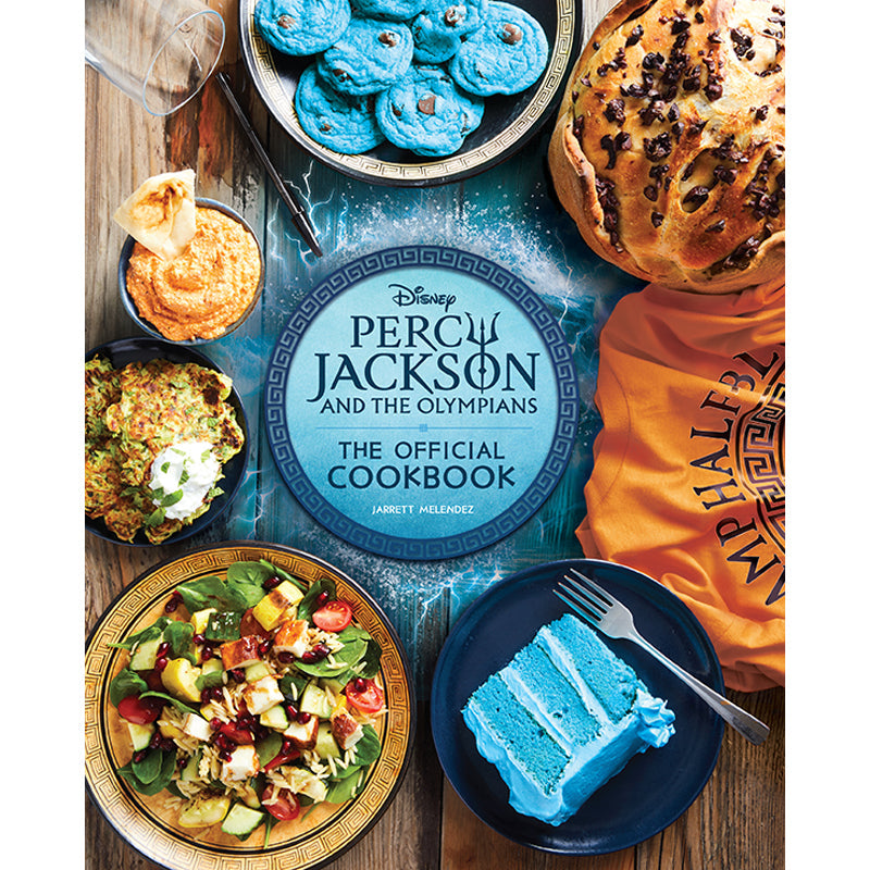 Cookbook titled 'Percy Jackson and the Olympians' with food items on a wooden table