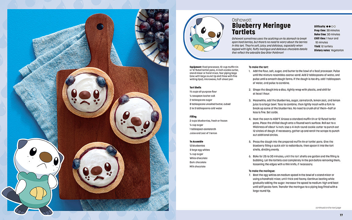 Blueberry meringue tartlets on a wooden board with recipe details on the side.