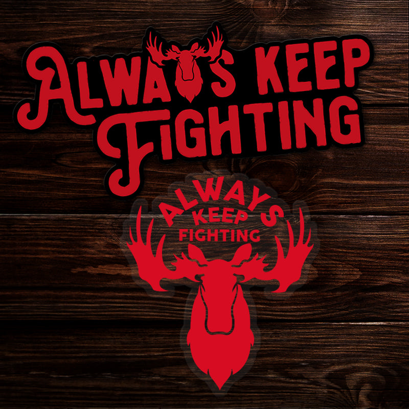 Red 'Always Keep Fighting' text with moose silhouette on a wooden background