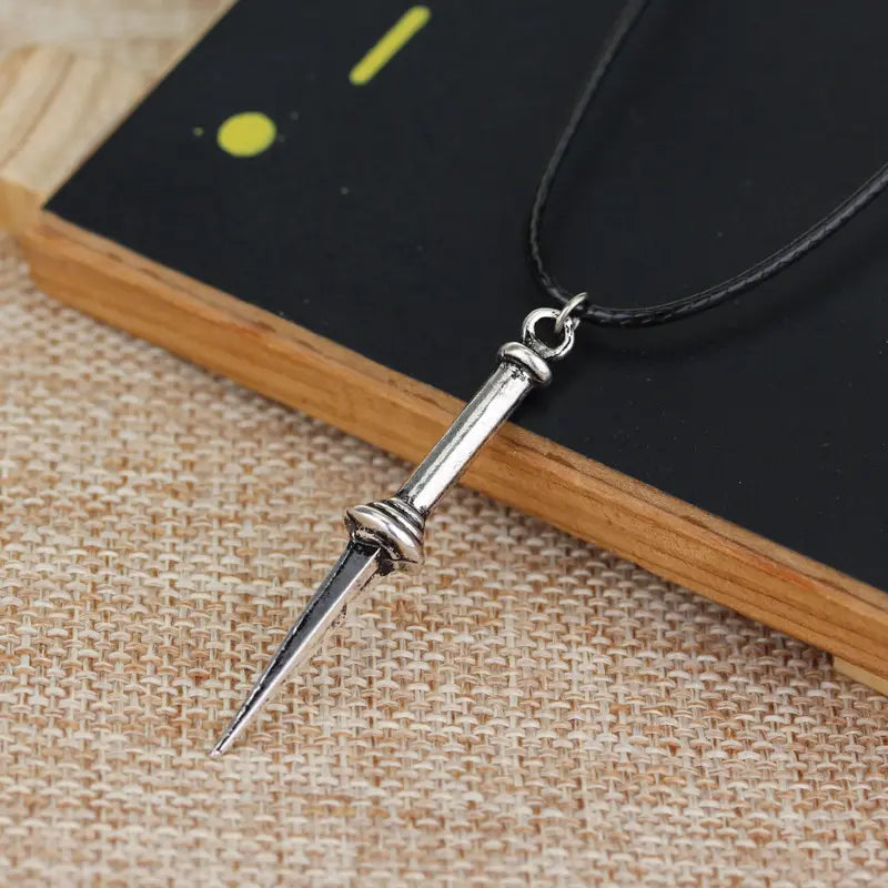 A necklace depicting the Angel Blade from Supernatural