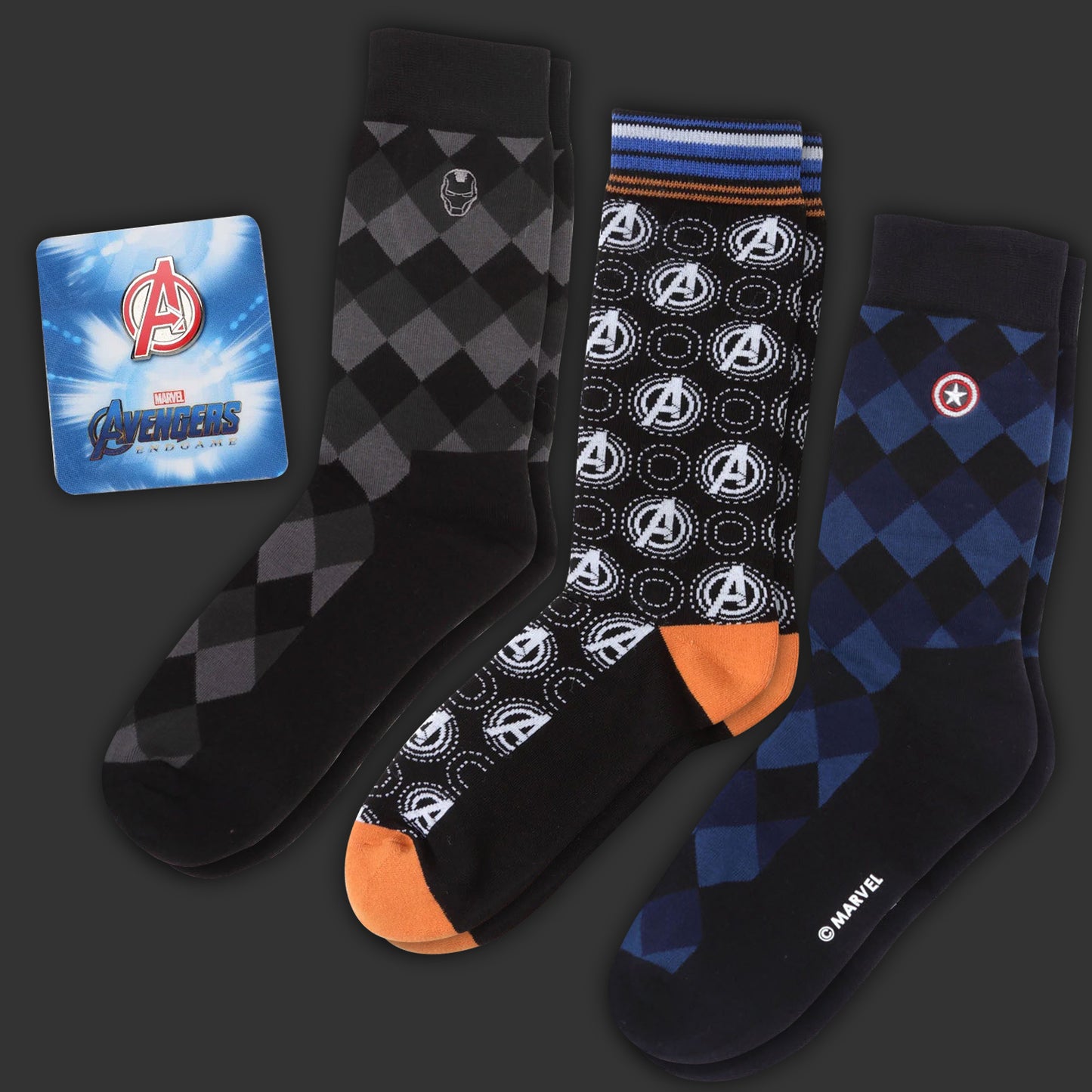 Three pairs of socks with Avengers logo and packaging on a dark background