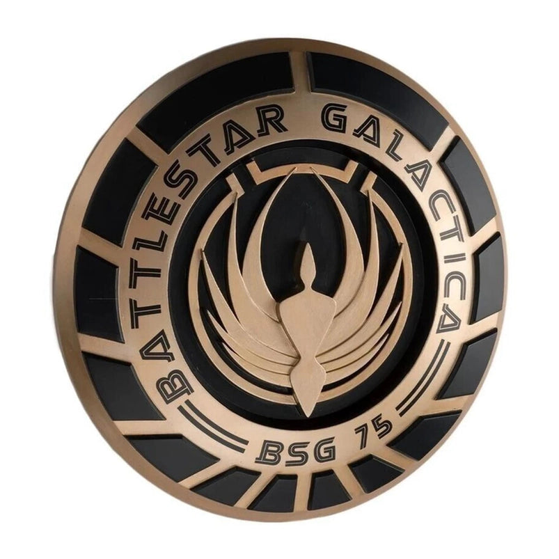 A bronze and black, round plaque, bearing the seal of the Battlestar Galactica.
