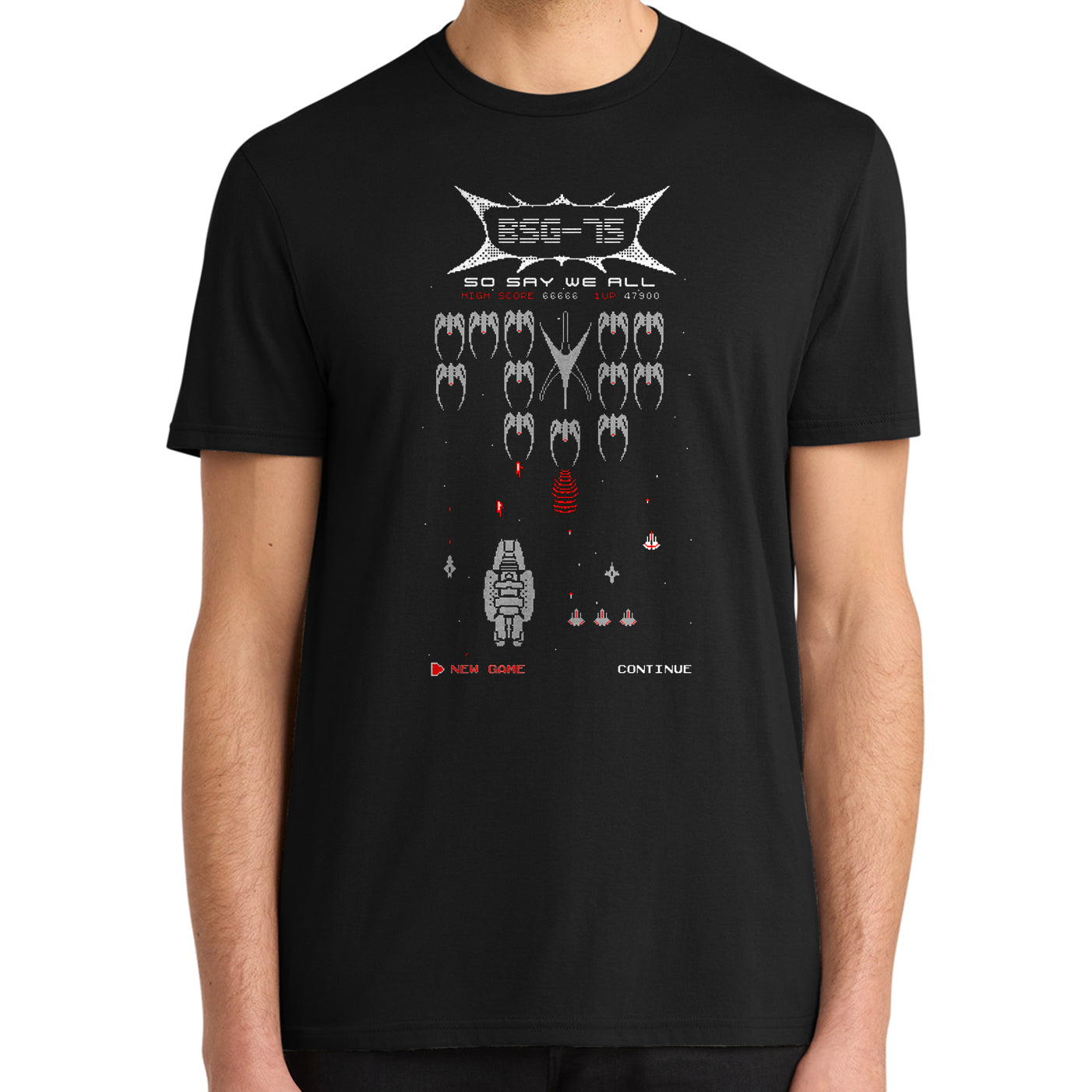 A man wearing a black short-sleeve t-shirt with a retro video game style graphic on the chest featuring the text 'BSG-15' and pixelated space-themed elements.