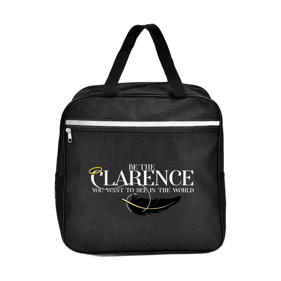 A black, square-shaped bag with a top handle and a slim silver reflective line. There's a front zipper and a front print that reads "Be the Clarence you want to see in the world" in white font, featuring a halo and black feather.