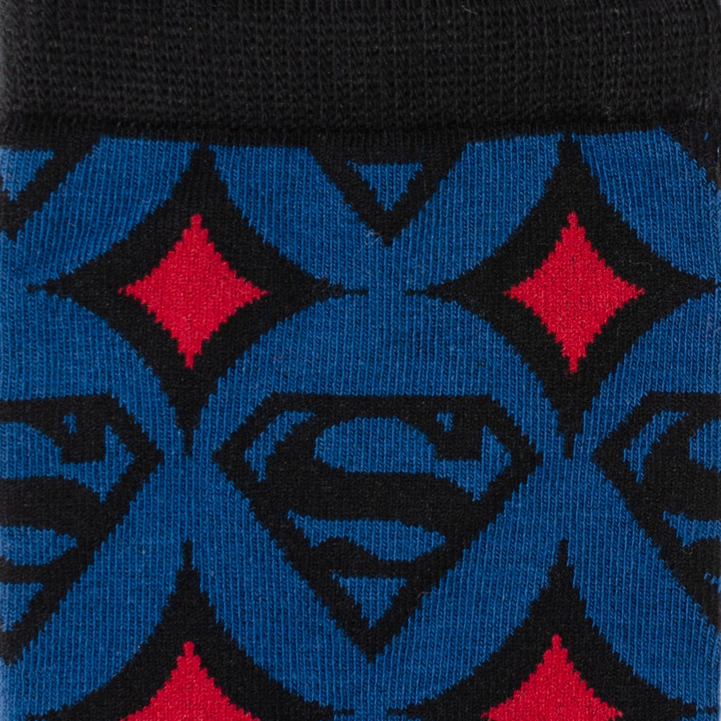 Close-up of Superman logo pattern on a blue and black background