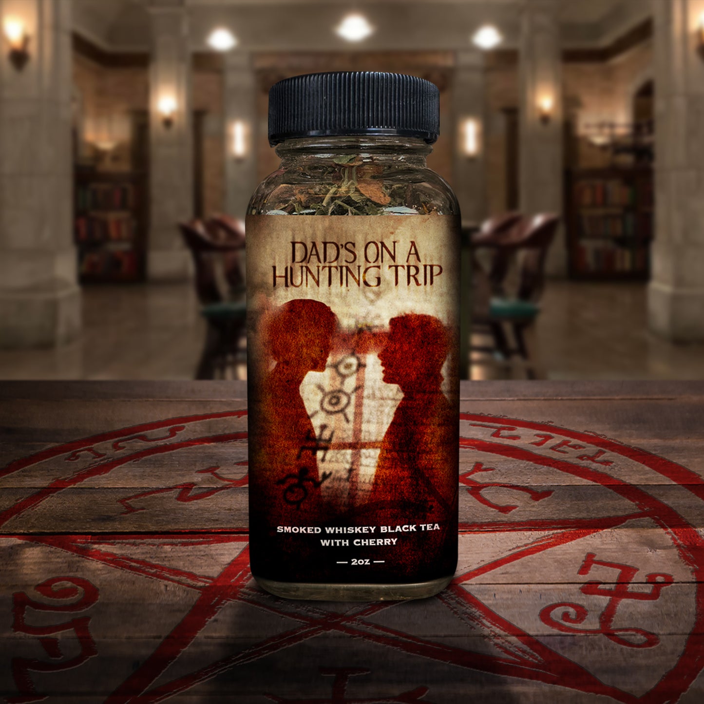 Bottle of 'Dad's on a Hunting Trip' tea on a wooden surface with a blurred background