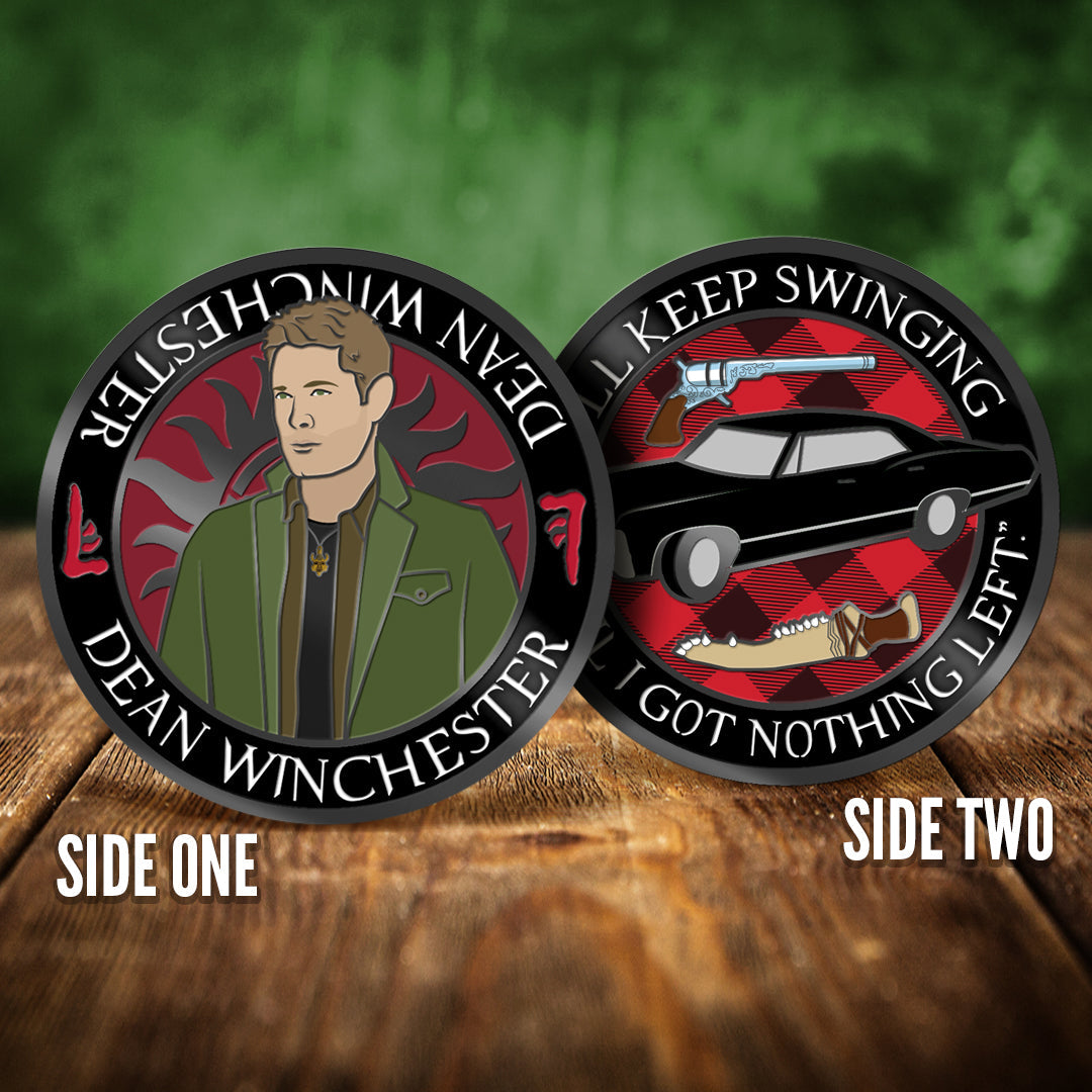 Front and back images of a challenge coin, side by side, on a wood table. The front depicts a drawing of Dean Winchester, wearing a green jacket and black shirt. Behind him is the edge of the anti-possession symbol. The back of the coin depicts a 1967 black Chevy Impala against a red and black plaid background. Above and under the car are a colt revolver and a dagger made from bone. White text around the edge says "I'll keep swinging til I got nothing left"