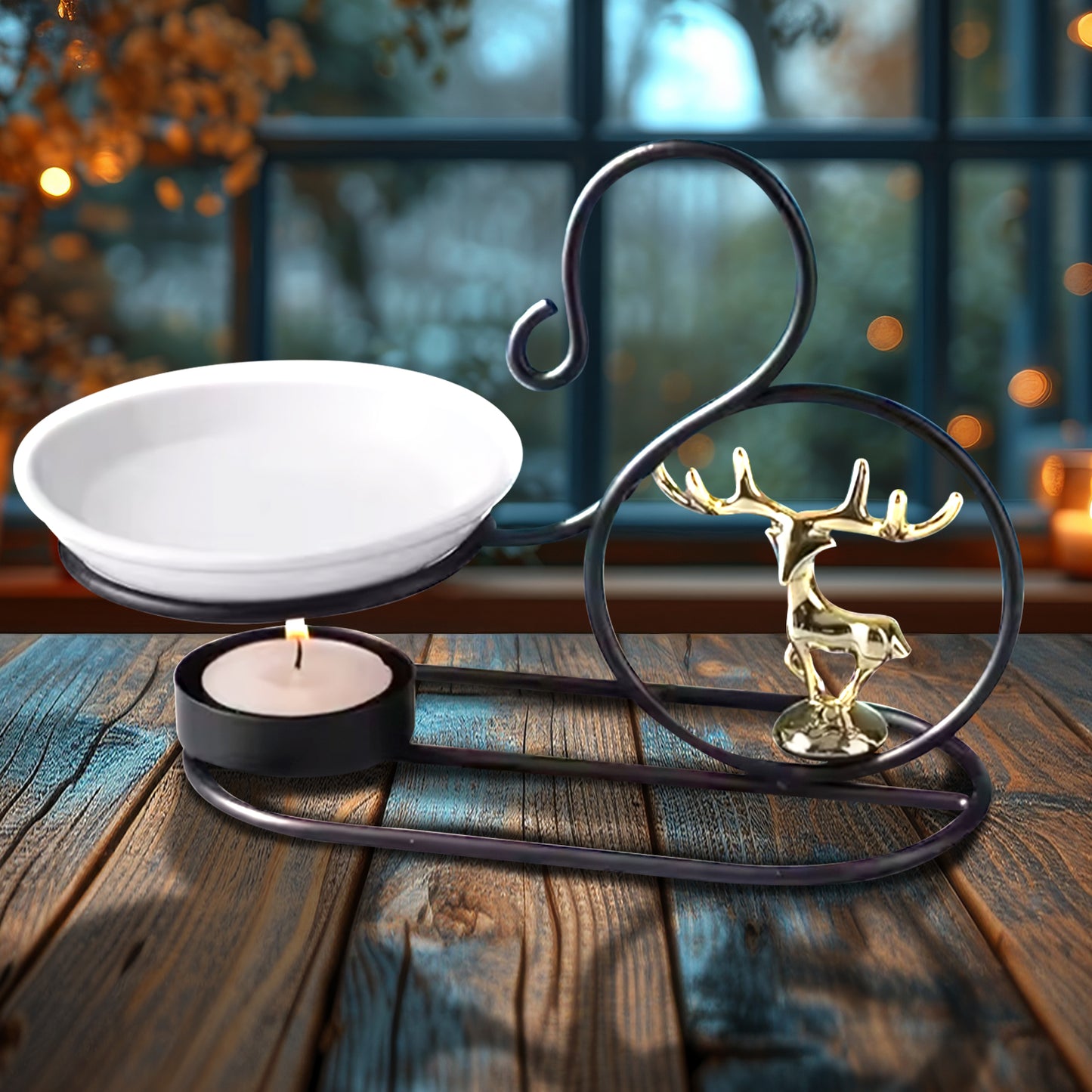 A curled black iron frame on a wood table. The frame has a white ceramic bowl at one end, filled with oil. Under the bowl is a small wax candle. Inside the frame's curl is a miniature golden stag figurine. In the background is a garden seen through window panes.