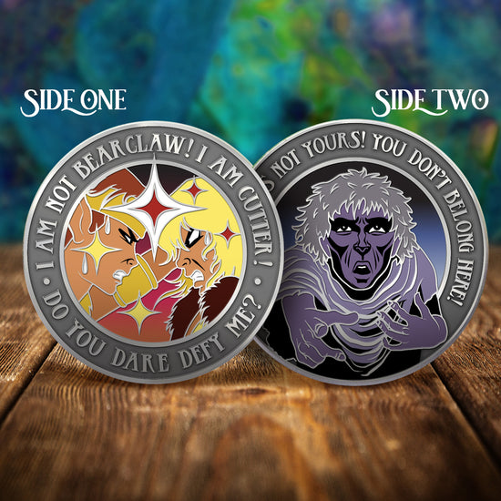 Two challenge coins side by side on a wooden table, with a swirling green and blue pattern in the background. The left coin depicts the ElfQuest characters Cutter and Strongbow glaring at each other. Text around the edge of the coin says "I am not bearclaw! I am Cutter! Do you date defy me?" The right coin depicts a human in purple. Text around the edge says "This world is not yours! You don't belong here!"