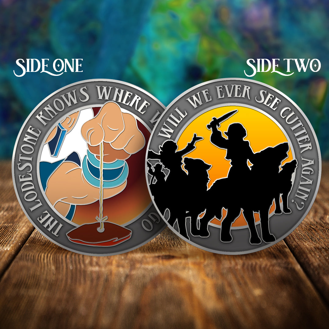 Two challenge coins side by side on a wooden table, with a swirling green and blue pattern in the background. The left coin shows a hand holding a rock on a string. Around the edge is text saying "the lode stone knows where we want to go." The right coin has silhouettes of elves riding on wolves, against a sunset colored background. Around the edge is text saying "will we ever see cutter again?"