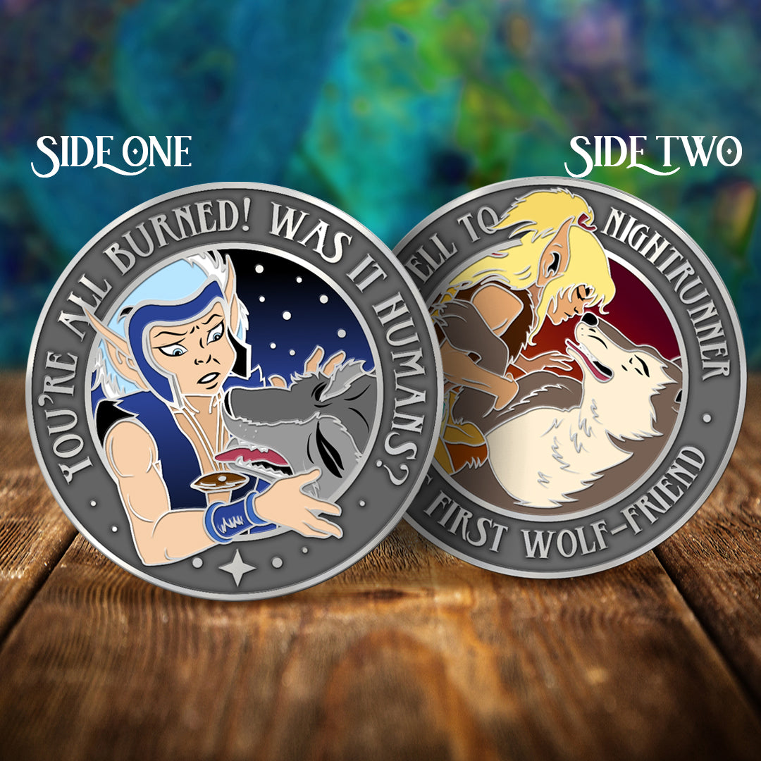 Side by side images of a challenge coin, depicting characters from the series ElfQuest. One side shows an elf in a blue vest, petting a grey wolf Text around the edge says "You're all burned! Was it humans?" The other side shows a blonde elf with a white and brown wolf. Text around the edge says "Farewell to nightrunner. His first wolf-friend."