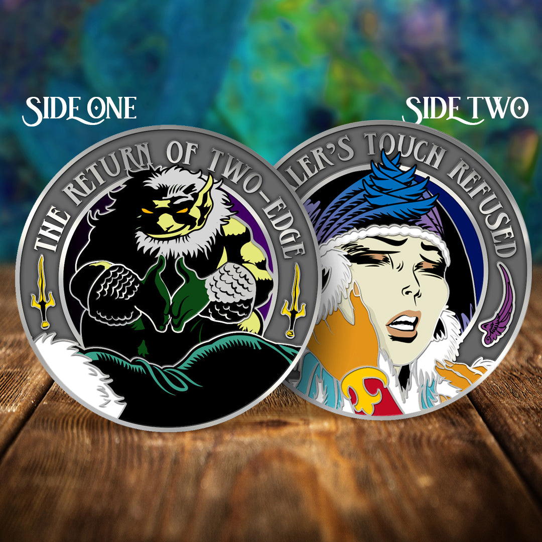 Two circular collectible coins or medallions displayed side by side on a wooden surface, labeled SIDE ONE and SIDE TWO. The left coin, titled 'THE RETURN OF TWO EDGES,' shows a black-and-white feline creature with green and yellow accents.