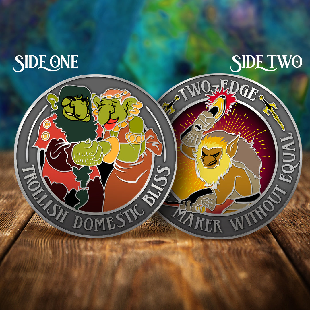 Two challenge coins side by side on a wooden table, with a swirling green and blue pattern in the background. The left coin depicts the married troll couple Picknose and Oddbit, holding hands. Text around the edge of the coin says "Trollish domestic bliss" The right coin depicts the half elf, half troll character two-edge, holding a hammer. Text around the edge says "Two-edge, weapons marker without equal."