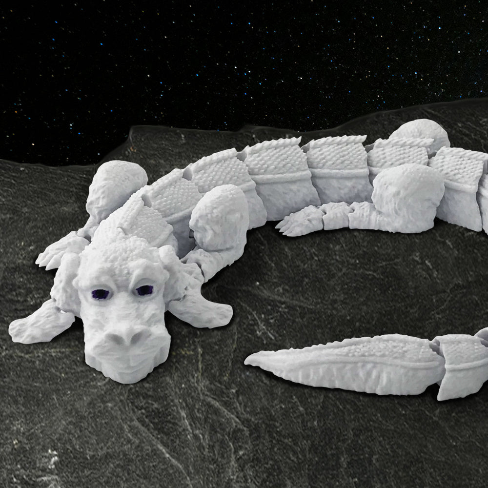 A light grey, 3D-printed rendition of Falkor the Luckdragon from The NeverEnding Story. It has dark black-purple eyes and 3D-printed joints that allow it to act as a fidget toy. The toy is edited into a celestiel background.