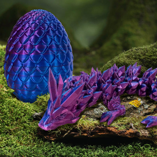 A long and flexible 3D printed, scaley-textured dragon in a holographic purple color. The dragon is beside a 3D printed egg of the same color and a smoother scaled texture.