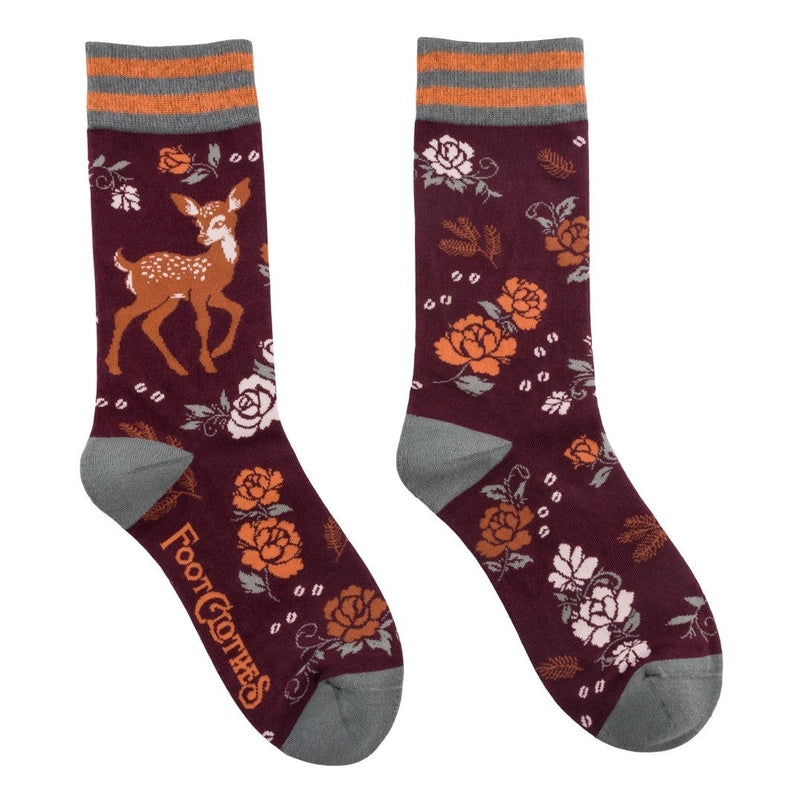 A pair of crew length maroon socks. The socks feature a pattern of orange and white flowers, with a brown fawn on the side.