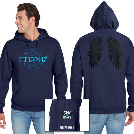 Front and back images of a model wearing a blue hooded sweatshirt. The front of the shirt has light blue runes, which spell out the word "funnier" in the angelic language Enochian. On the left sleeve is a pair of black wings with white and blue text that says "SPN 20 years." The back of the shirt has a pair of large black angel wings.