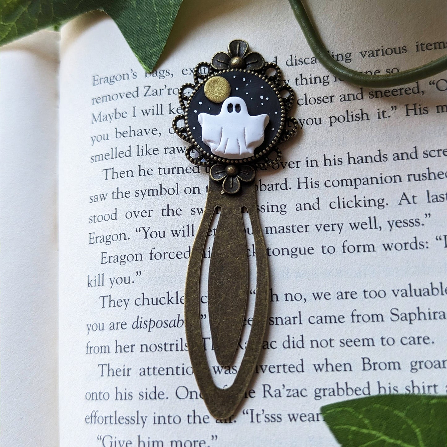 Ghost-themed bookmark on an open book with leaves