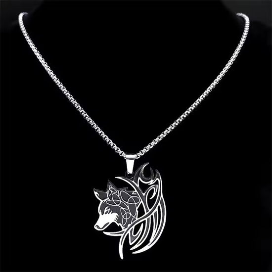 A silver necklace in the shape of a sideways-facing wolf's head with a swirling Norse-inspired design. The charm is on a silver chain.