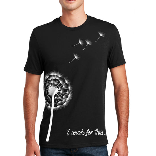 A male model wearing a black t-shirt. On the front is a white drawing of a dandelion with four seeds floating off. At the bottom is white scripted text that says I wish for this.