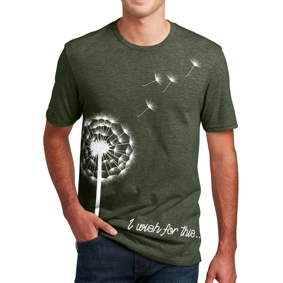 A male model wearing a forest green t-shirt. On the front is a white drawing of a dandelion with four seeds floating off. At the bottom is white scripted text that says I wish for this.