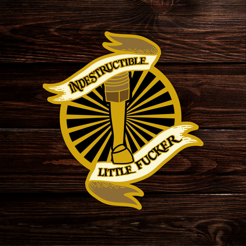 A sticker depicting a pirate leg surrounded by sun rays. Text says "indestructible little fucker"