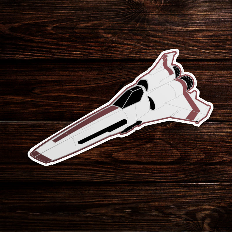 A sticker on a wooden table depicting a Viper fighter ship from the TV series Battlestar Galactica