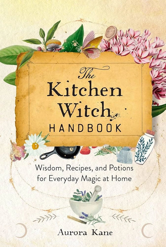 An ivory and tan book against a white background. The front cover depicts a drawing of a parchment rectangle, with black text saying "The kitchen witch handbook." Above the parchment is a drawing of leaves and pink flowers. Black text underneath says "wisdom, recipes, and potions for everyday magic at home." At the bottom is a drawing of a white mortar and pestle filled with green herbs.