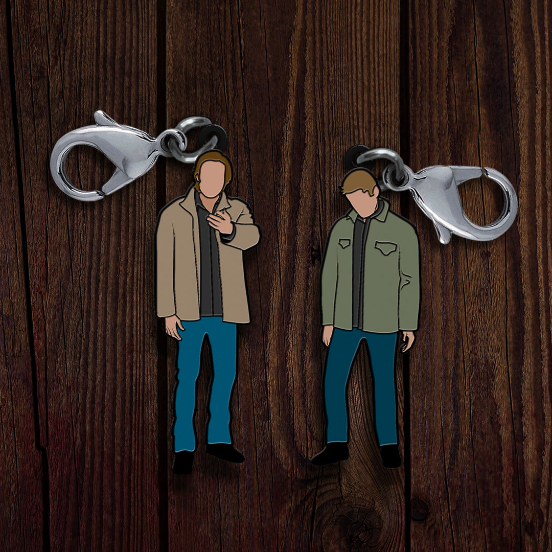 A pair of metal charms, depicting the Supernatural characters Sam and Dean